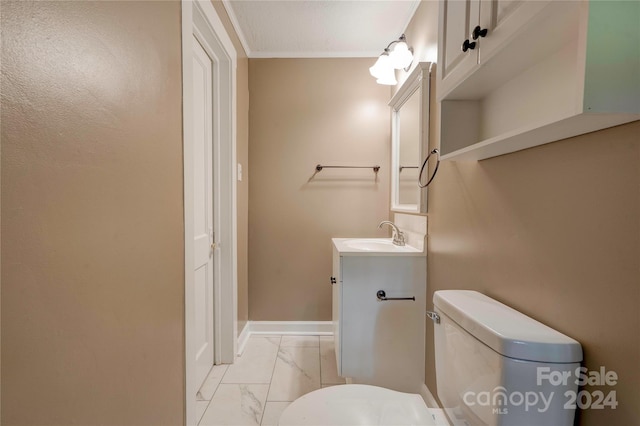 bathroom with toilet, ornamental molding, and vanity