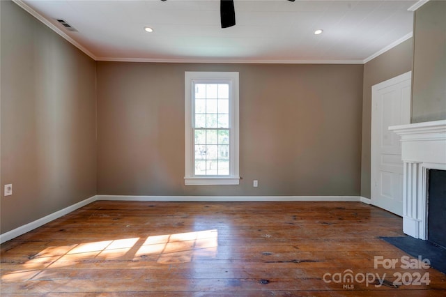 unfurnished living room with wood-type flooring and ornamental molding