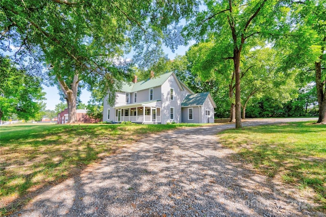 colonial inspired home with a front yard and a porch