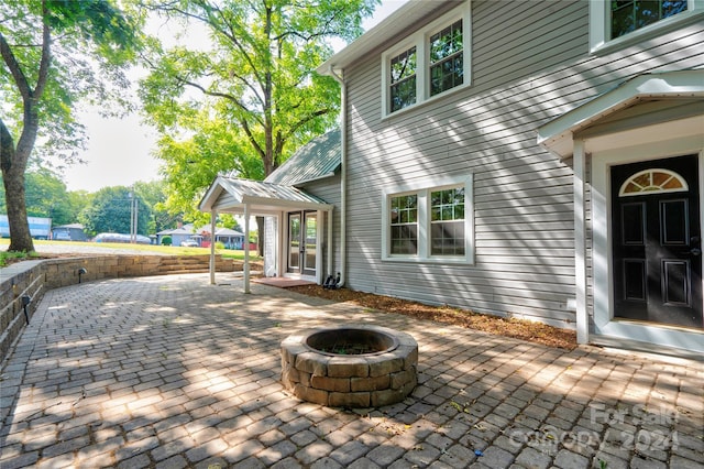 view of patio / terrace featuring an outdoor fire pit