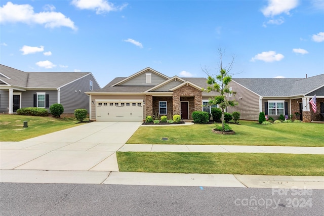 view of front of house featuring a front yard and a garage