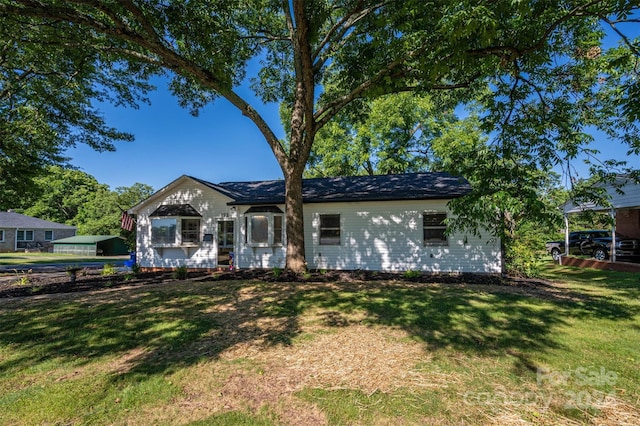 ranch-style home with a front lawn