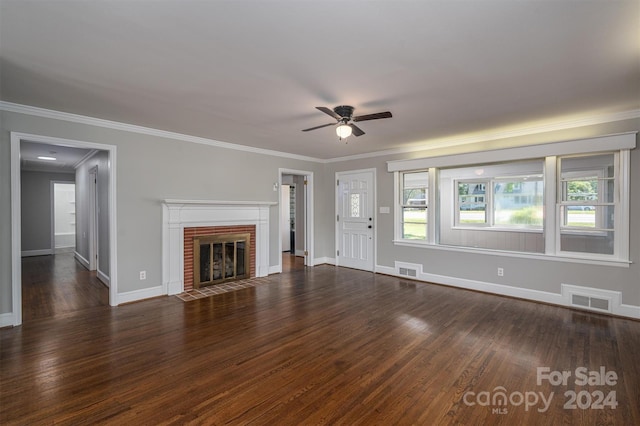 unfurnished living room with crown molding, a fireplace, ceiling fan, and dark wood-type flooring