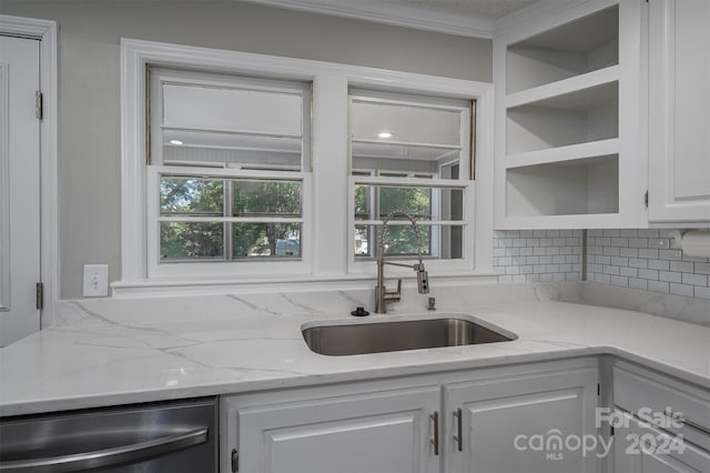 kitchen featuring white cabinetry, dishwasher, sink, tasteful backsplash, and light stone counters