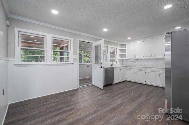 kitchen featuring sink, dark hardwood / wood-style flooring, a textured ceiling, white cabinets, and appliances with stainless steel finishes