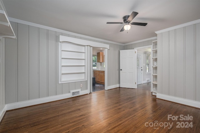 unfurnished bedroom with ensuite bath, crown molding, ceiling fan, and dark wood-type flooring