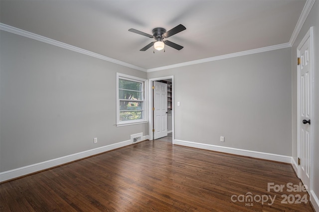 empty room featuring dark hardwood / wood-style flooring, ceiling fan, and ornamental molding