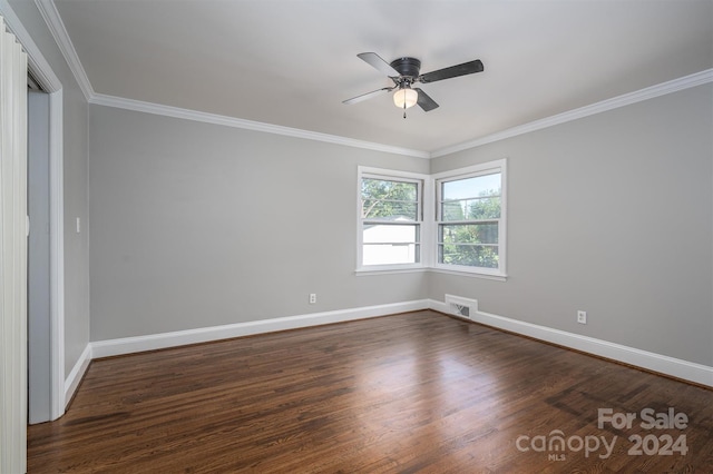 unfurnished room with ceiling fan, ornamental molding, and dark wood-type flooring