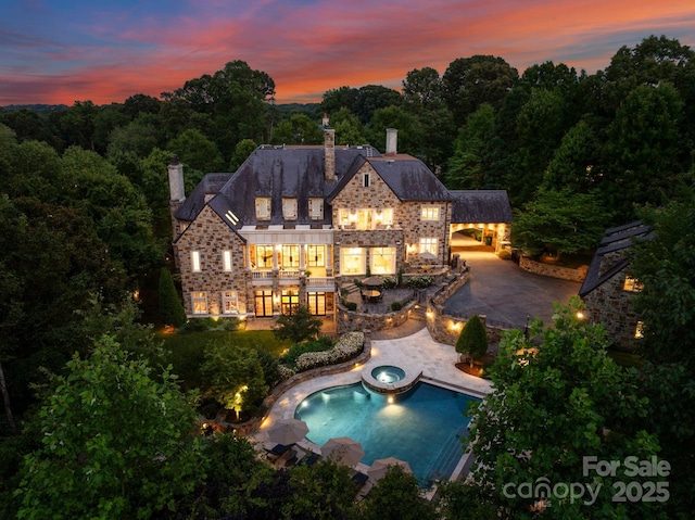 back house at dusk with a patio