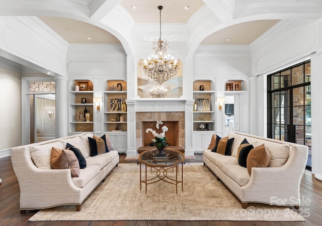 living room featuring ornate columns, built in features, a fireplace, and coffered ceiling