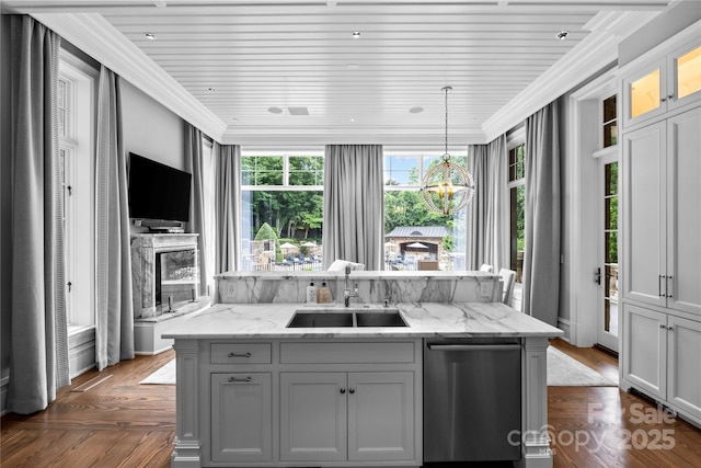 kitchen with gray cabinetry, light stone countertops, sink, and ornamental molding