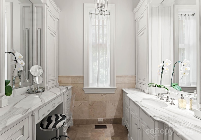 bathroom with vanity and tile walls