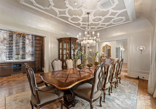 dining space with hardwood / wood-style floors and an inviting chandelier