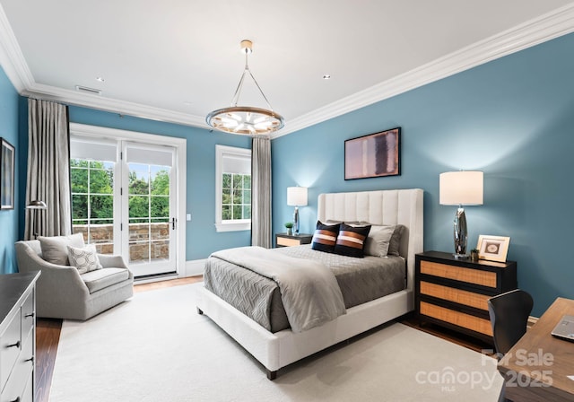 bedroom featuring access to outside, hardwood / wood-style flooring, and ornamental molding