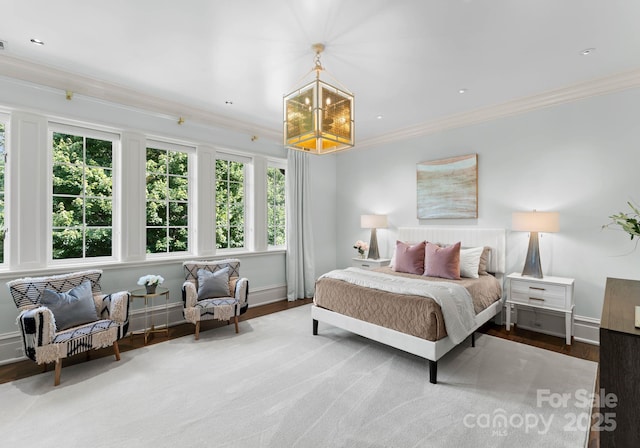 bedroom with crown molding and a notable chandelier