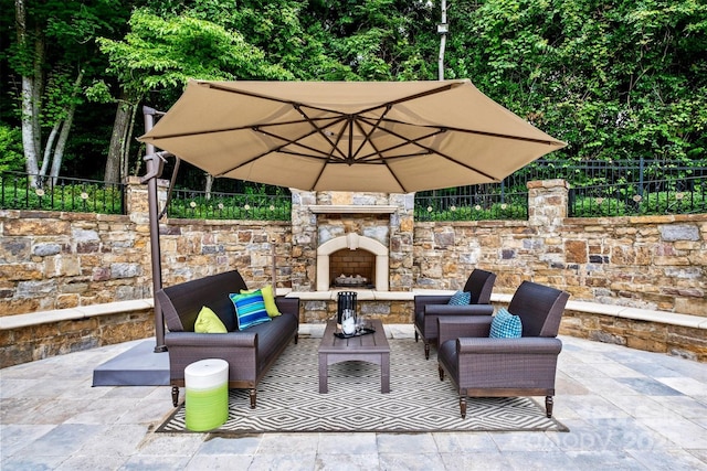 view of patio featuring an outdoor living space with a fireplace