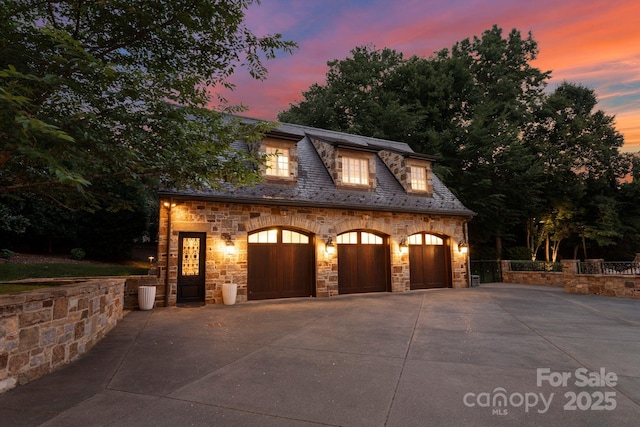 view of garage at dusk