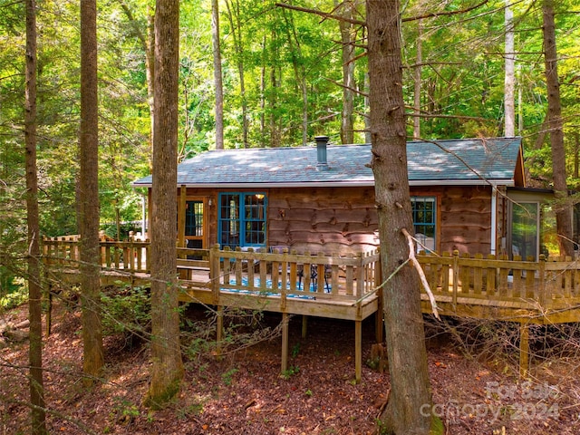 rear view of property with a wooden deck