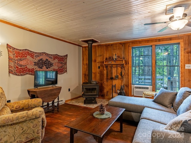 living room featuring dark hardwood / wood-style floors, crown molding, wooden walls, a wood stove, and wooden ceiling