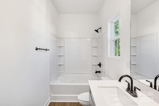 full bathroom featuring toilet, hardwood / wood-style floors, vanity, and bathtub / shower combination