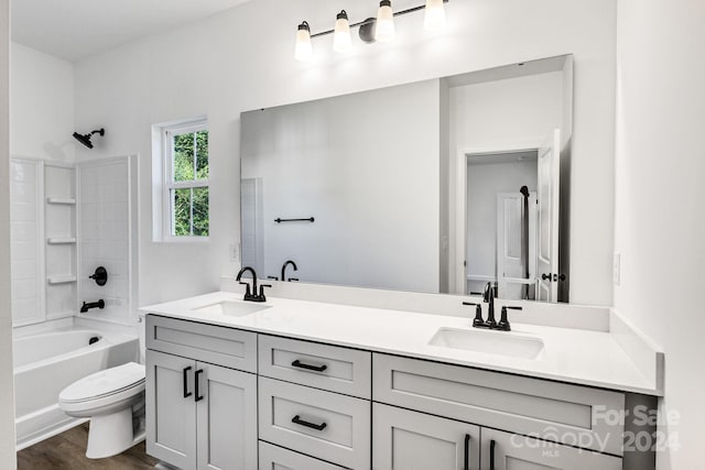 full bathroom featuring toilet, vanity, wood-type flooring, and  shower combination