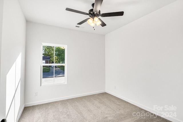 empty room with ceiling fan and carpet