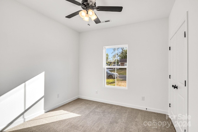 carpeted empty room featuring ceiling fan