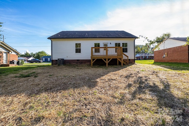 back of property featuring central AC unit and a wooden deck