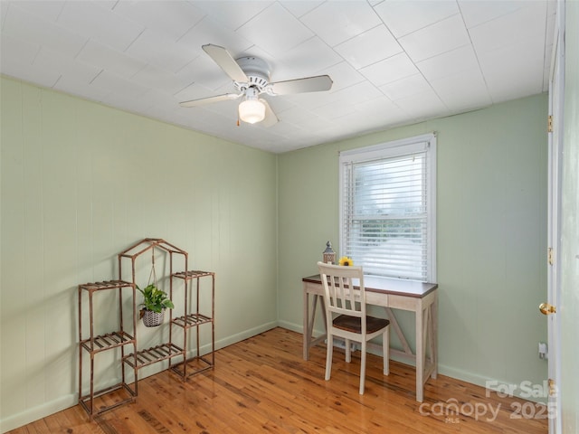 home office with hardwood / wood-style flooring and ceiling fan