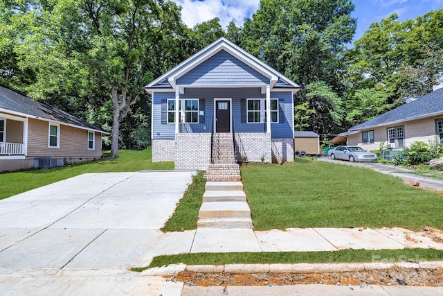 bungalow featuring central AC and a front yard