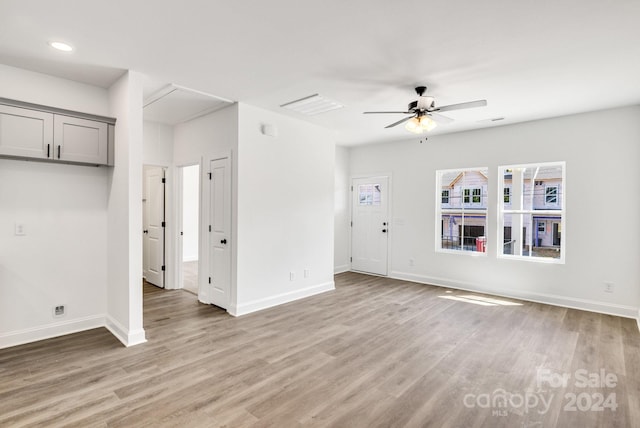 unfurnished living room featuring wood-type flooring and ceiling fan