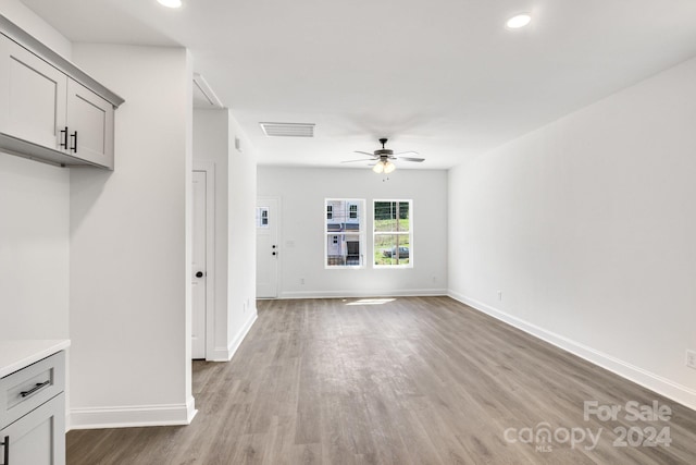 unfurnished living room featuring hardwood / wood-style floors and ceiling fan