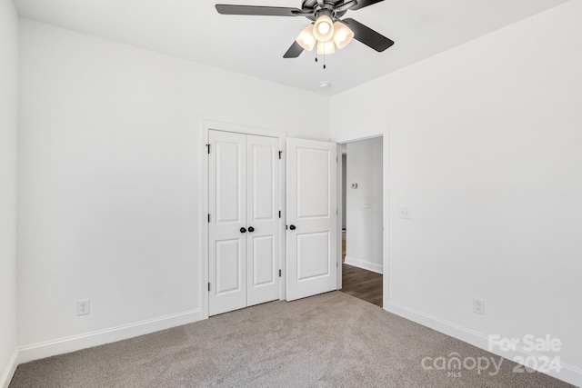 unfurnished bedroom with carpet flooring, a closet, and ceiling fan