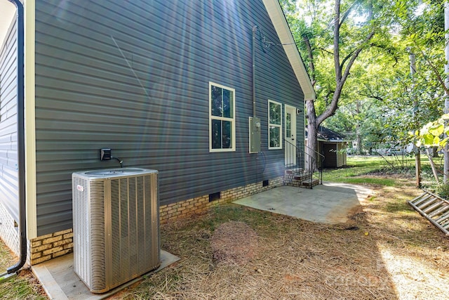 view of home's exterior with central air condition unit and a patio area