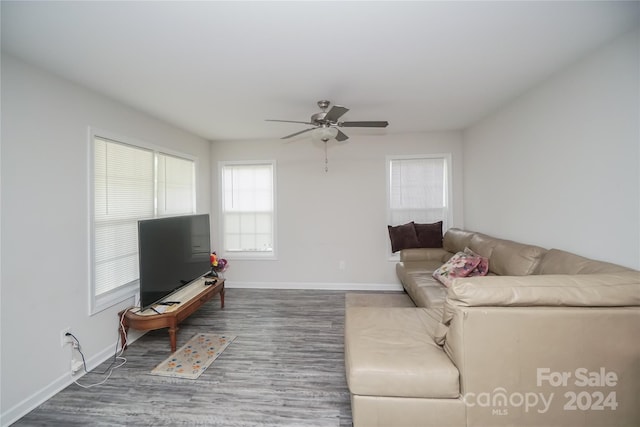 living room featuring ceiling fan and hardwood / wood-style flooring