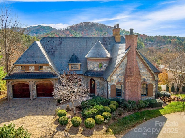 view of front of house with a mountain view and a garage