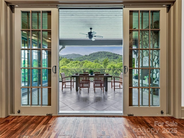 doorway to outside featuring ceiling fan, a mountain view, and wood-type flooring