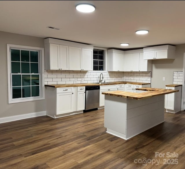 kitchen featuring dark wood-style floors, dishwasher, and wood counters