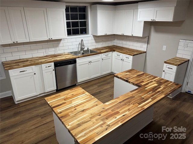 kitchen with backsplash, dark wood-type flooring, a sink, butcher block countertops, and dishwasher