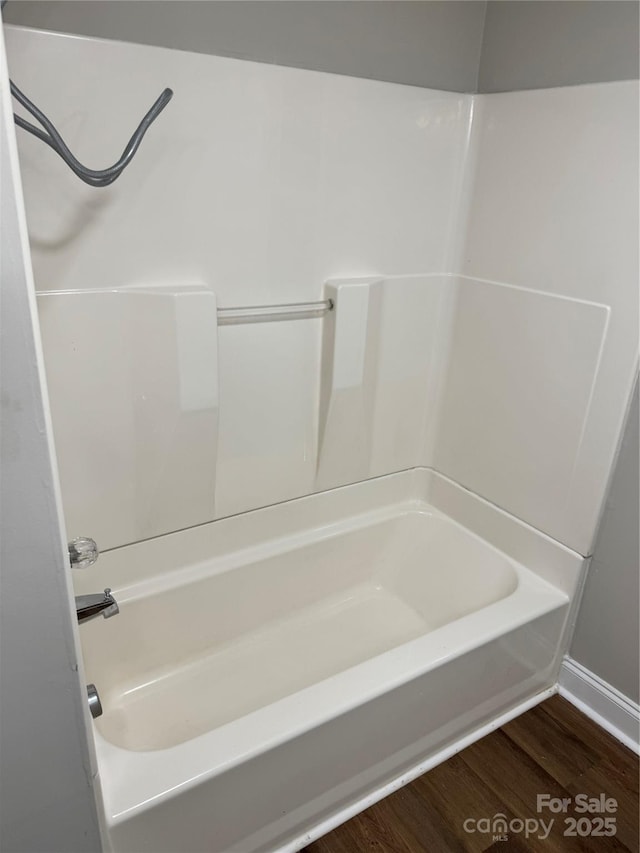 full bathroom featuring shower / tub combination and wood finished floors