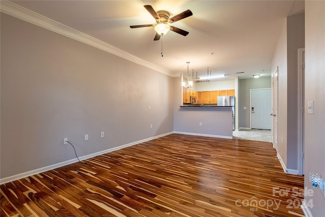 unfurnished living room with dark wood-type flooring, ornamental molding, and ceiling fan