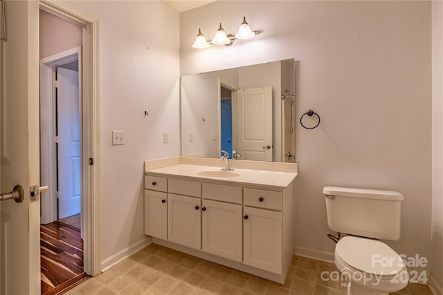 bathroom with toilet and vanity