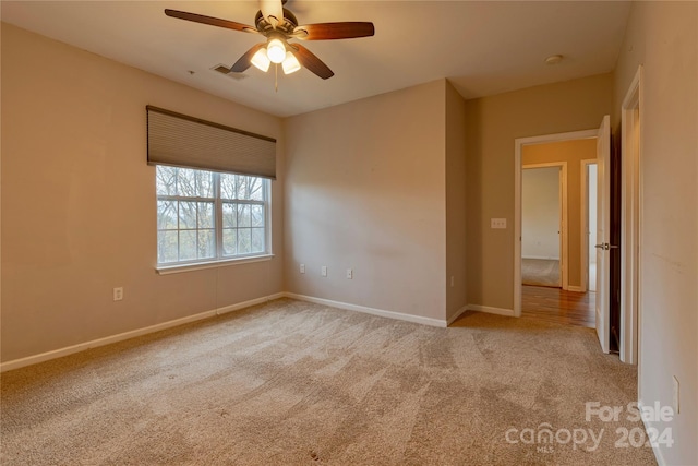 carpeted empty room with ceiling fan