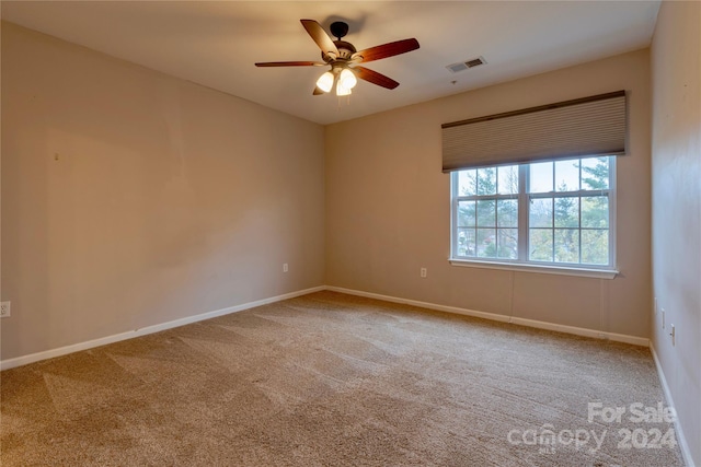 empty room with ceiling fan and carpet flooring