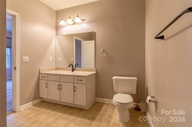 bathroom with toilet and vanity