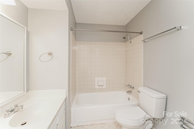 full bathroom featuring toilet, tile patterned floors, vanity, a textured ceiling, and tiled shower / bath combo