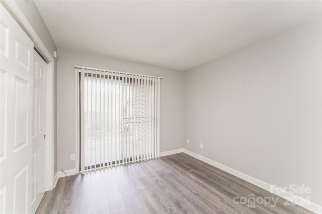 unfurnished bedroom with a closet and hardwood / wood-style floors