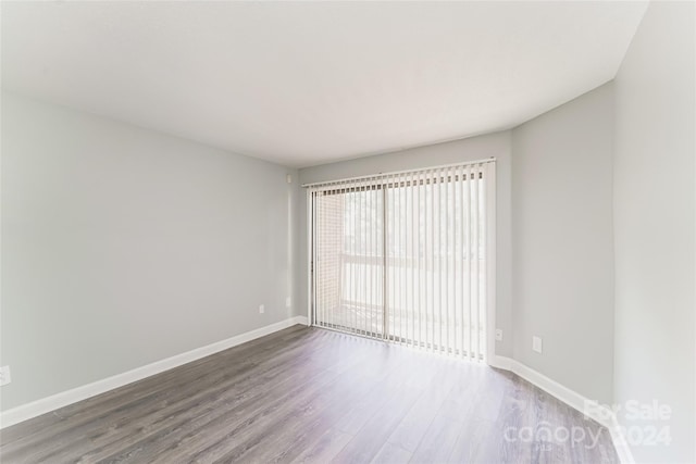 empty room with hardwood / wood-style flooring