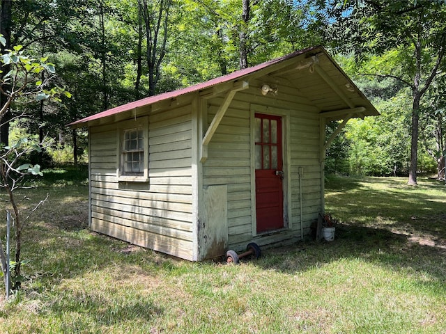 view of outbuilding with a lawn