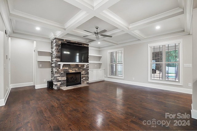 unfurnished living room with beam ceiling, a fireplace, coffered ceiling, and built in shelves